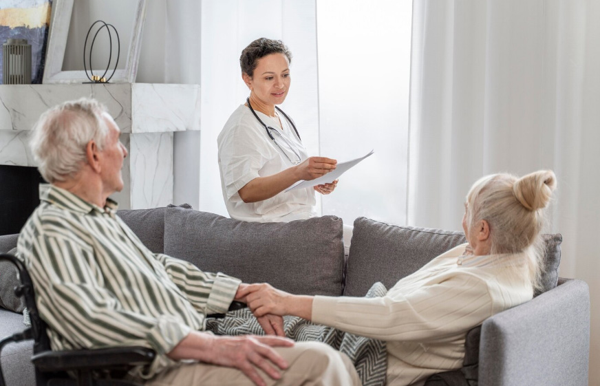 Caregiver reviewing Medicare hospice coverage documents during open enrollment in a Georgia home